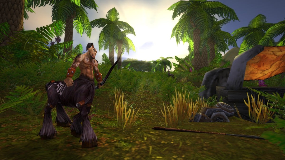 Centaur standing in the middle of Barrens in WoW Classic. In the background are lush trees and a deep sunset.