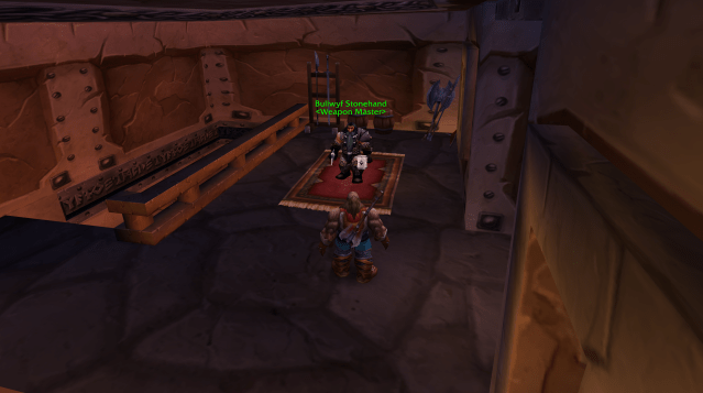 A WoW Classic player stands before the weapons trainer in Ironforge