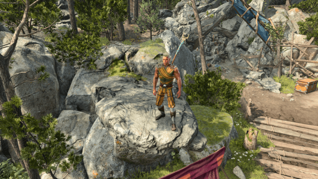 A wood elf monk sits on the first camp's rock in Baldur's Gate 3. He wears the game's traditional monk wrappings, with a yellow, green, and blue X around his chest, green undershirt, yellow and green striped pants, and leather shoes. The rock sits above a tent, and another small outcropping sits behind him.