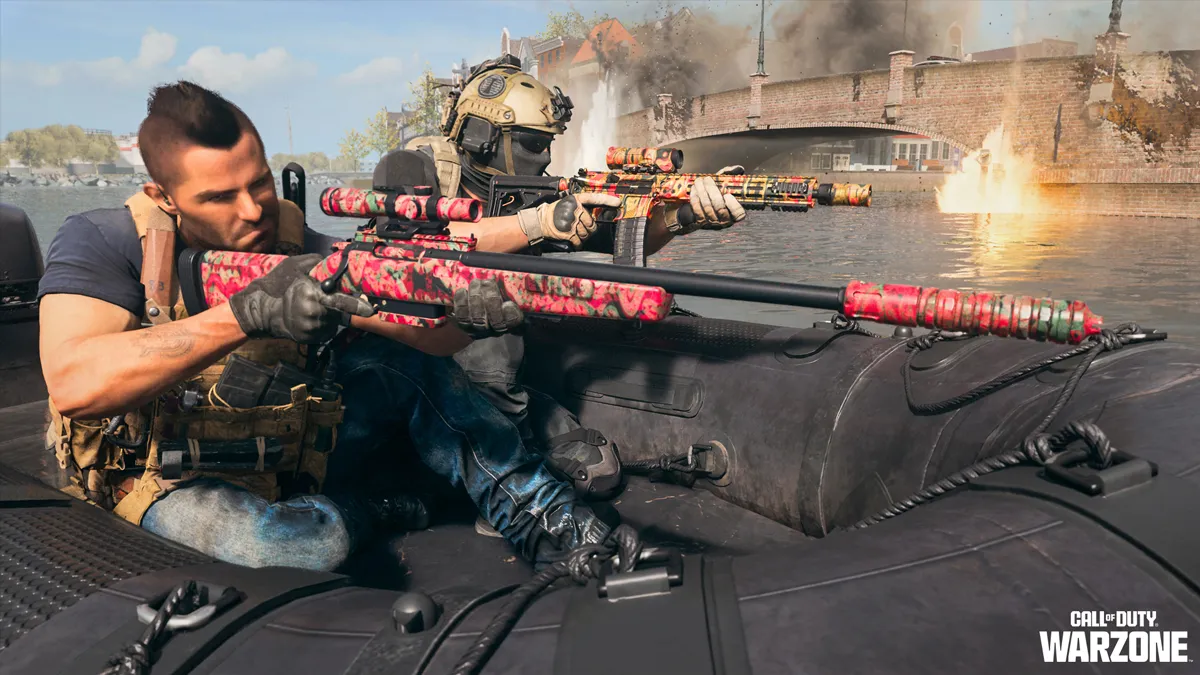 An operator wields a pink sniper rifle while their teammate fires a rifle from a boat in Warzone.