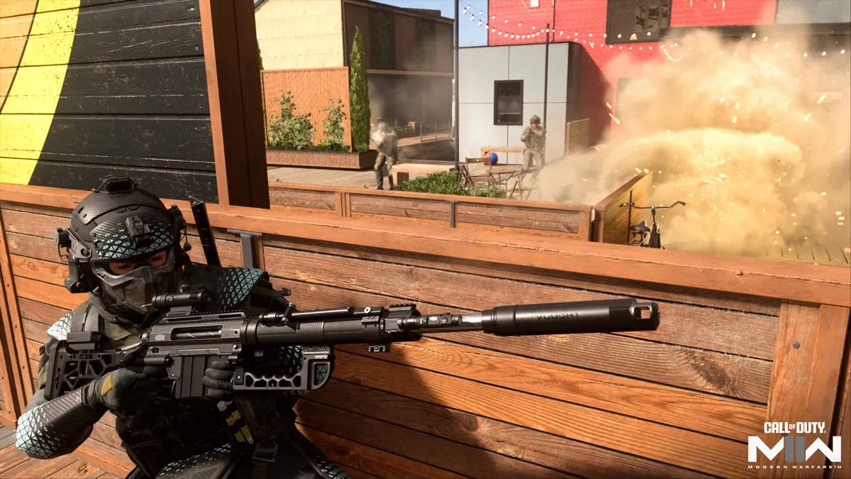 A Task Force 141 soldier in blue and black armor comes under fire at a park bench, as enemy soldiers begin to close on their location in Call of Duty.