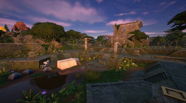 Rumble Ruins, and old temple sitting behind an area of marsh with grass, plants, tents, and ruins.