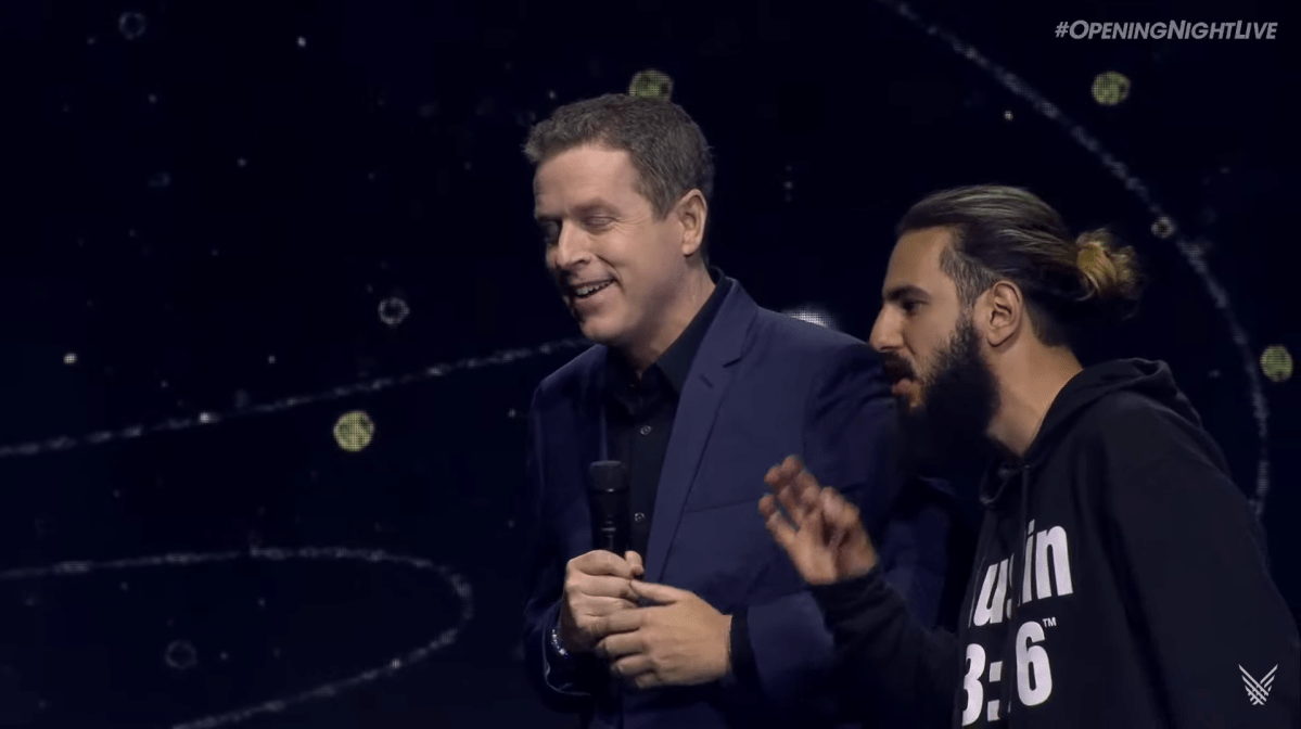 Geoff Keighley turns away from an unruly stage invader.