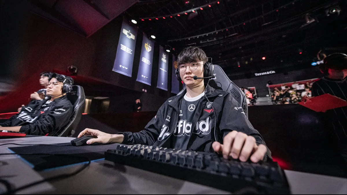 Faker, a League of Legends player for T1, sits at his PC and plays in front of an audience at the LCK Summer 2023 playoffs.