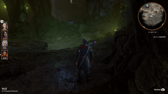 A glowing green chasm reveals itself in the cave in front of Wyll.