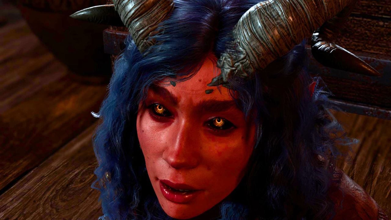 Woman with red skin and horns sitting on the ground in BG3
