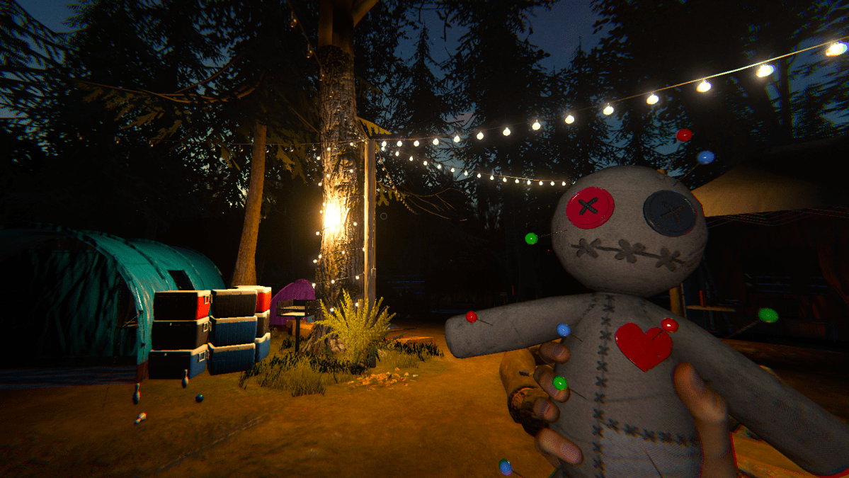 The player holding a voodoo doll in their right hand and staring at a lit up camp while searching for a ghost.
