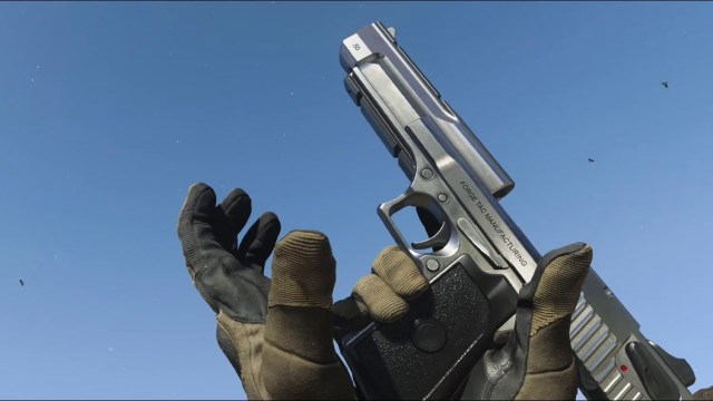 A player reloading a silver Desert Eagle pistol. 