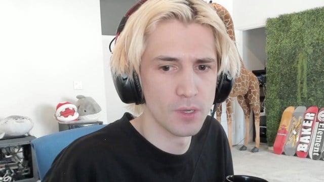 xQc looking flabbergasted at the camera in his streaming room.
