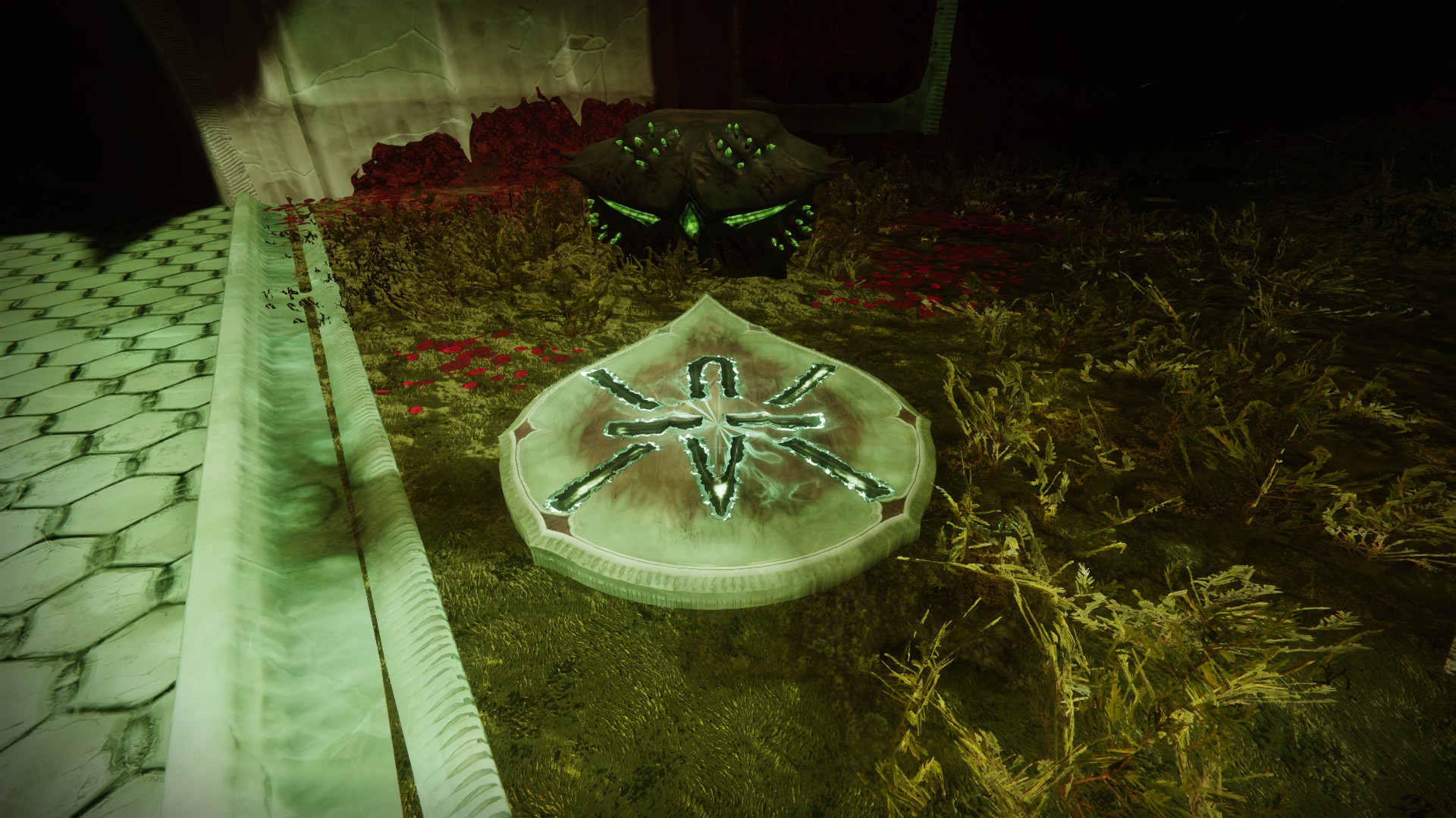 A chest on some grass. There's a Hive Rune that looks like a piece of barbed wire on a plate in front of this chest.