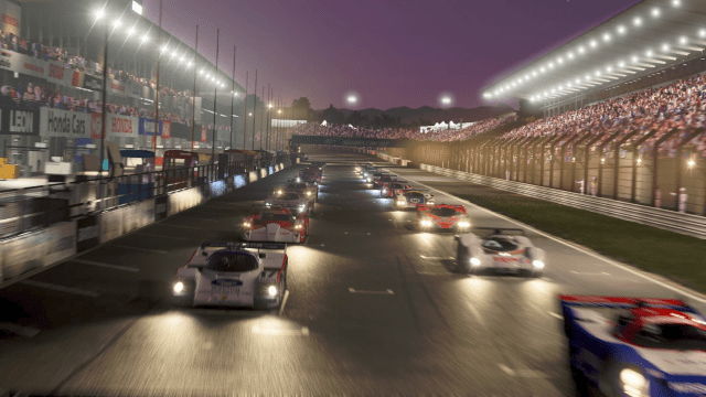 A grid of cars prepare for a race at night in Forza Motorsport.
