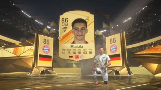 Jamal Musiala is unpacked in EA FC 24 Ultimate team, standing in front of a board showing his card.