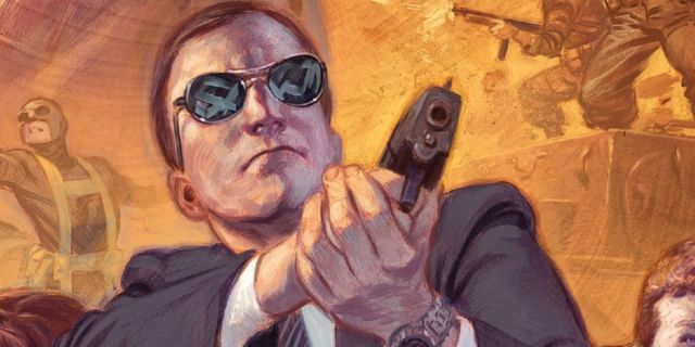 Agent Coulson, holding his gun and wearing his shades