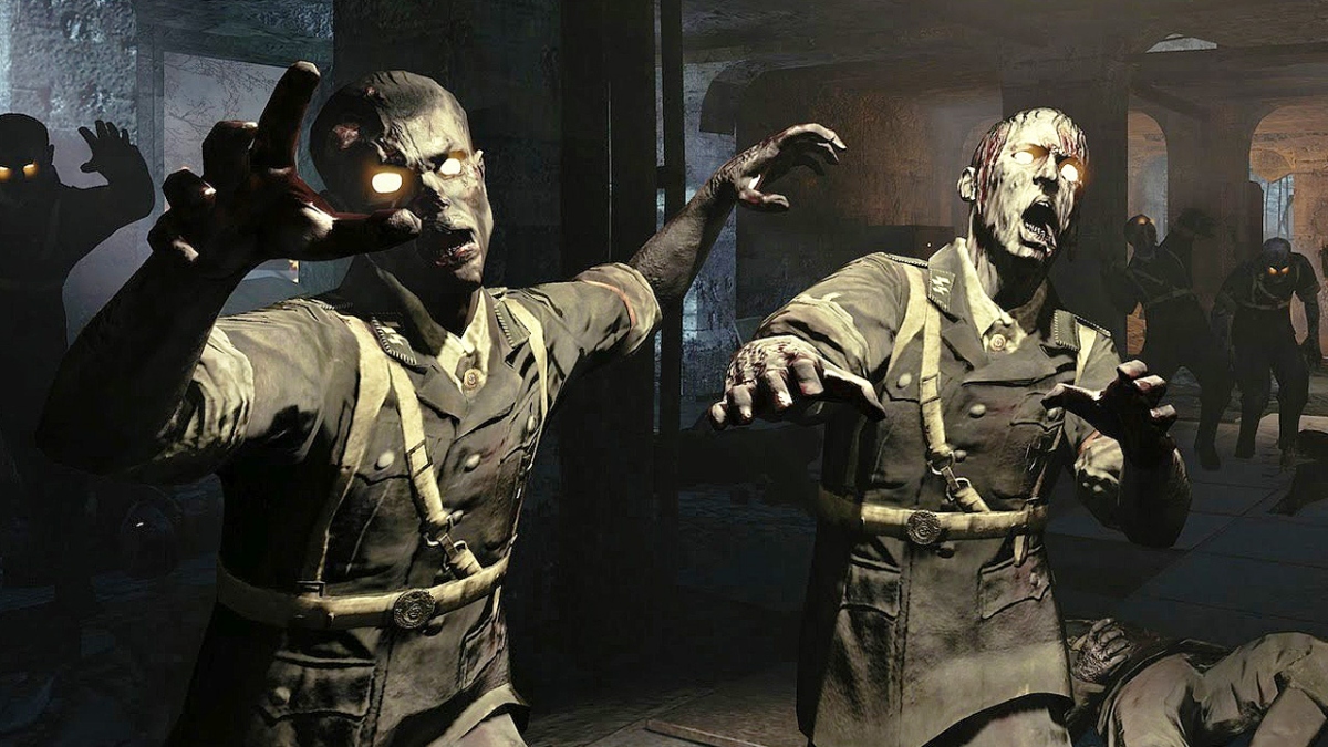 Two zombies walking towards the camera in a dimly lit room