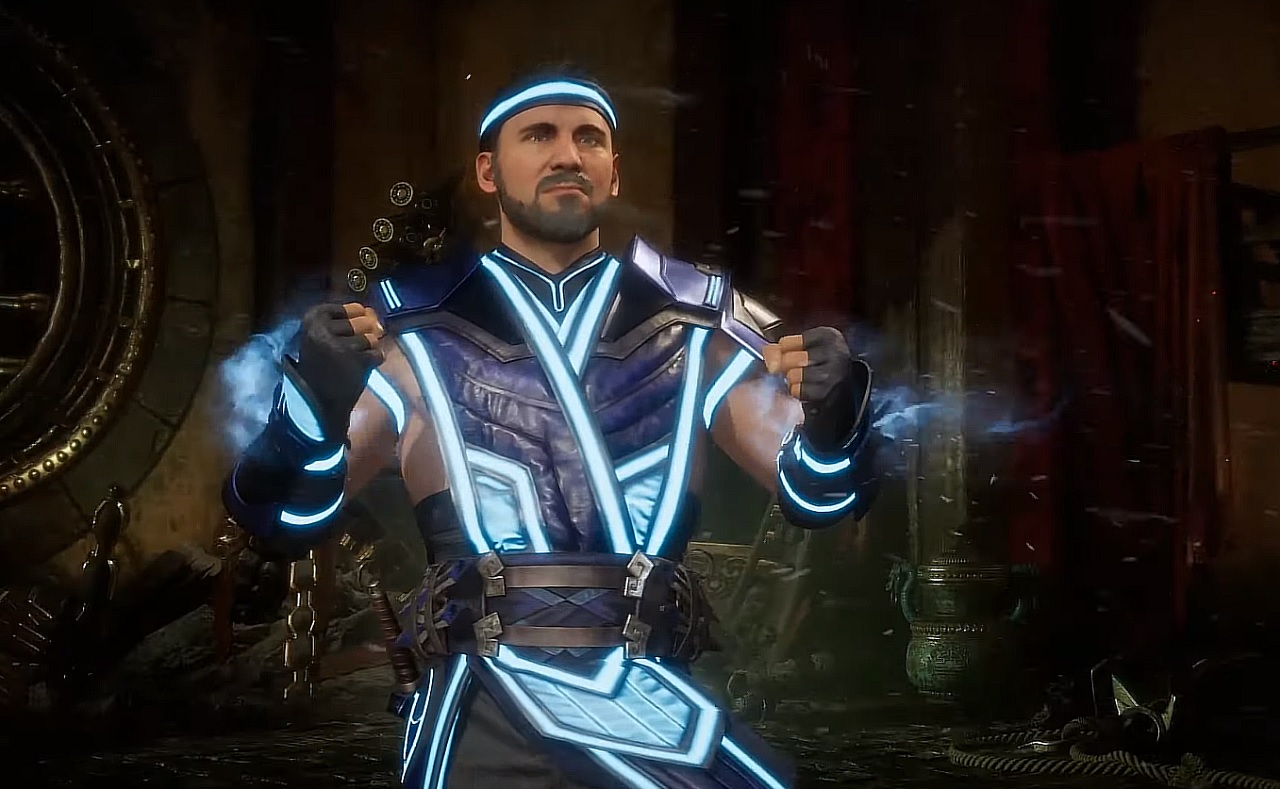 Sub-Zero is standing with some ruins behind him. His outfit is glowing blue.