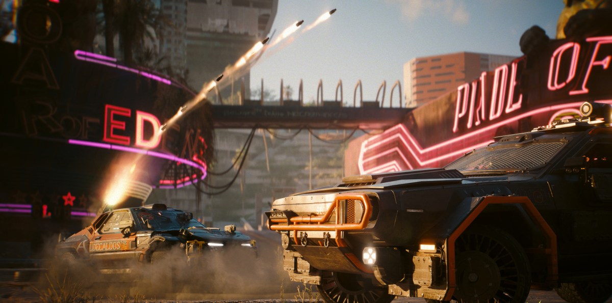 Two cars in Cyberpunk 2077 are shown, with one firing rocket launchers into the air.