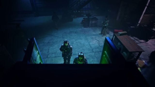 Image showcasing Ghost at shipping containers along with Captain Price. There is a visible blue light situated on the ground in the background.