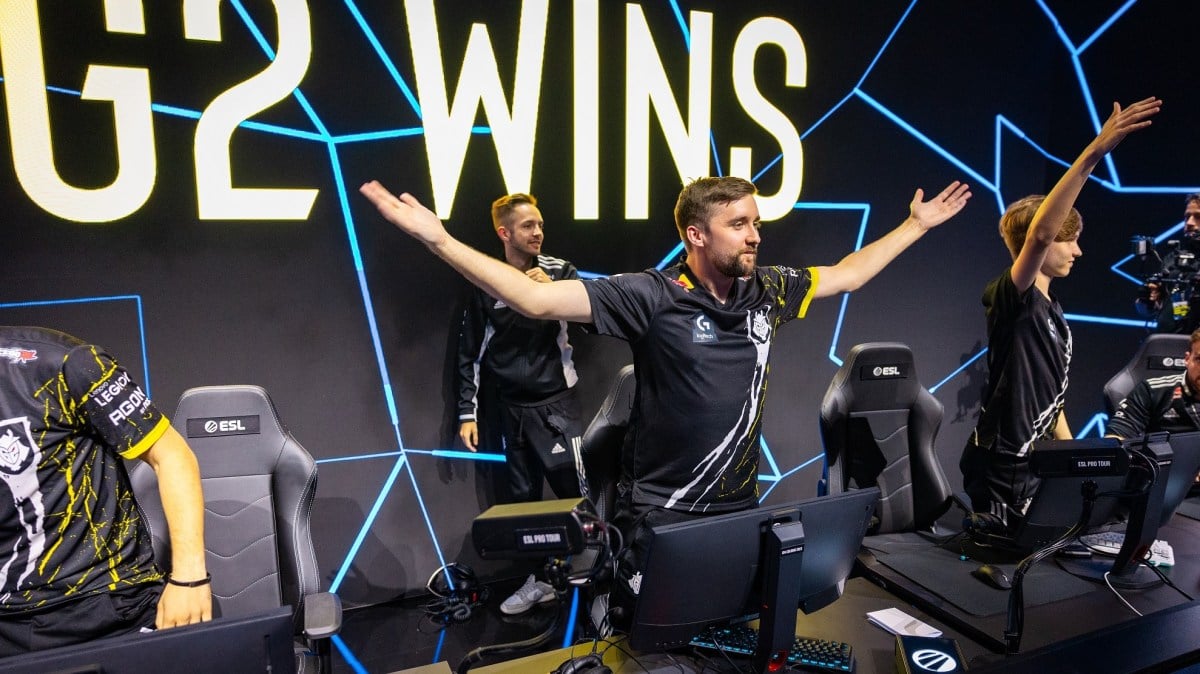 G2's CS:GO captain celebrates after they won a match at IEM Cologne in 2023. HooXi is with his arms wide open staring at the cameras.