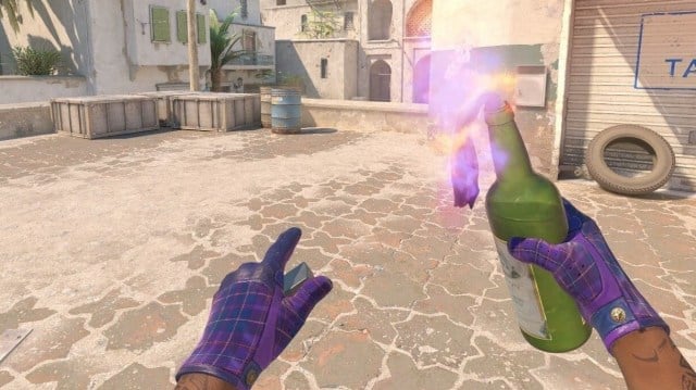 CS2 player holding Molotov grenade on Dust 2