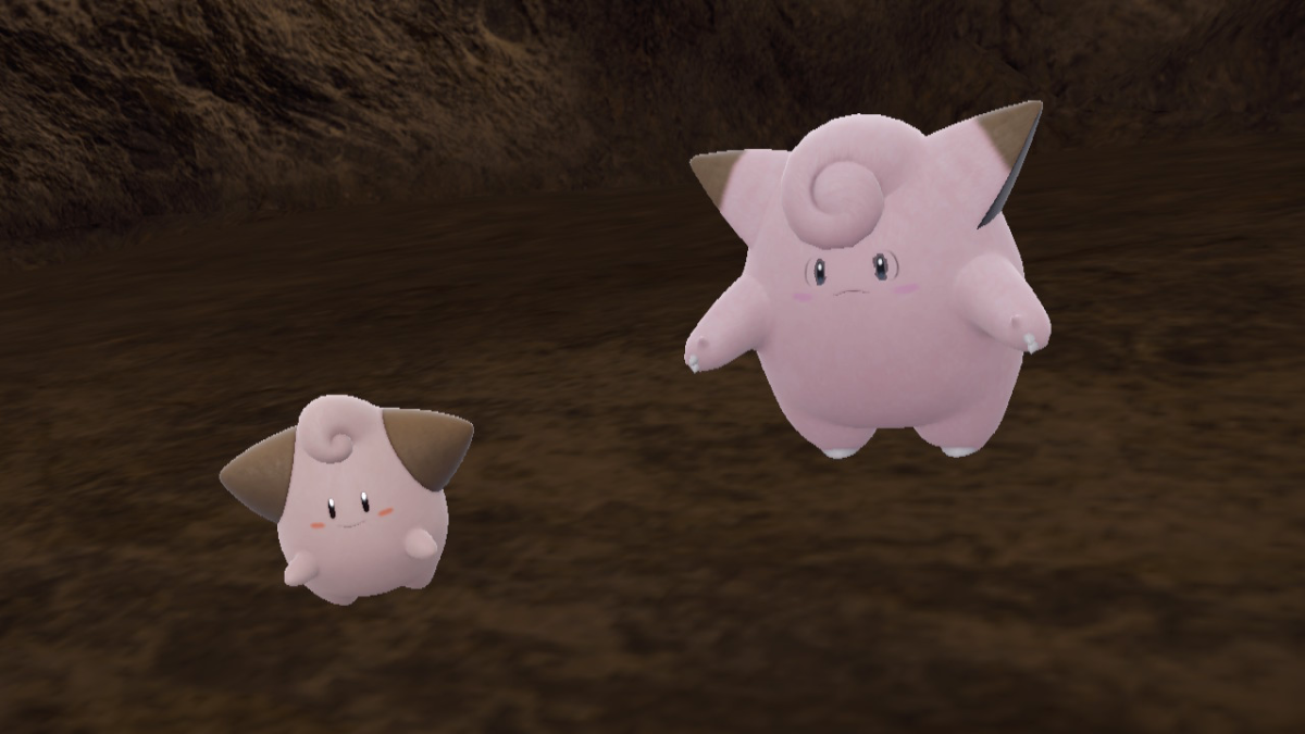 Clefairy and Cleffa, two pink marshmallow-like Pokemon, stand side by side in a cave in the Teal Mask DLC.