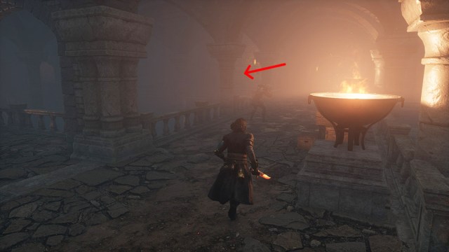 An arrow pointing to the left of a burning brazier in Lies of P