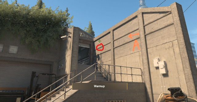 A CS2 character holding a smoke up towards Top Bathroom in Overpass.