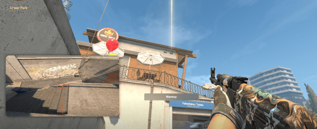 A CS2 character holding an AK-47 up towards bank on Overpass.
