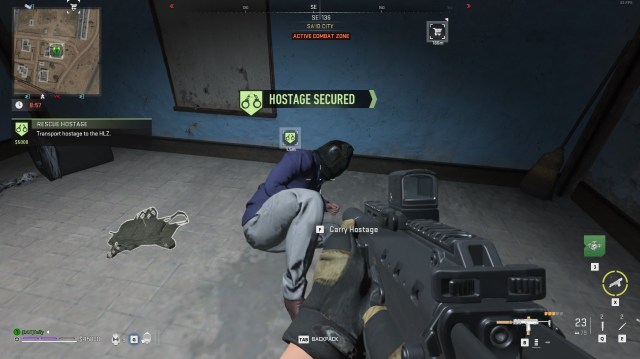 A soldier aims their gun at a hostage with a bag over their head, cowering on the floor as they're being rescued in DMZ.