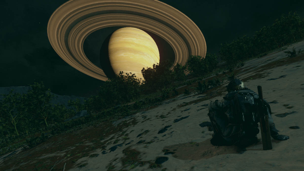 Displays a character sitting down and a ringed planet in the distance in Starfield.