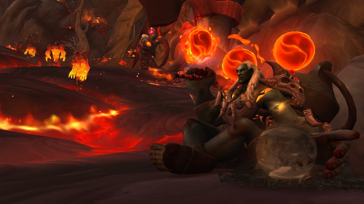 Glowing fire orbs in WoW's new zone, the Emerald Dream. Lava can be seen flowing in the background of the image.