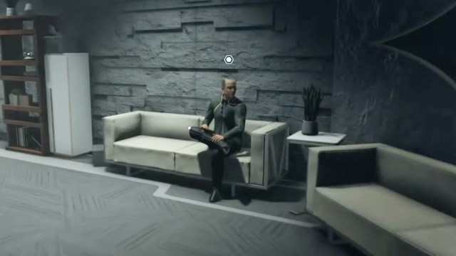 Agent Plato sitting on a couch.