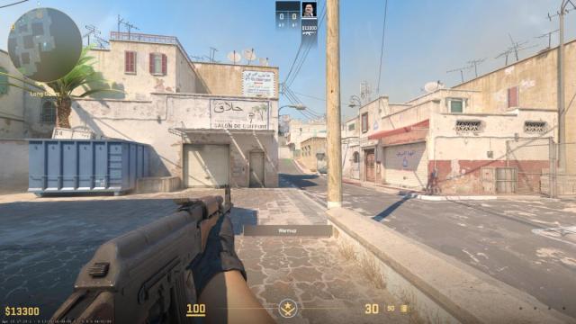 CS2 player holding AK in left hand on Dust 2