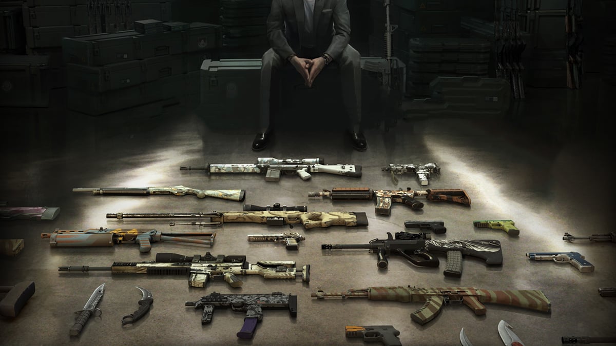 A man wearing a suit sits atop a weapon case while a selection of CS:GO guns with skins sit on the floor in front of him.