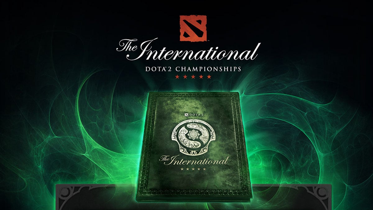 A green book with the Aegis of Champions on it surrounded by mysterious green energy below the classic Dota 2 The International logo.