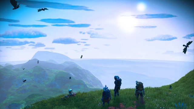 A screenshot from No Man's Sky: Origins featuring several characters sitting on a grassy peak overlooking a breathtaking landscape.