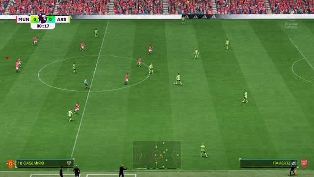 Manchester United vs. Arsenal in EA FC 24. Two teams playing football on a pitch.