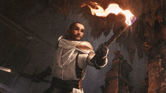 A man in white robes holds a burning torch in one hand, a longsword in the other, in a cave of MtG.