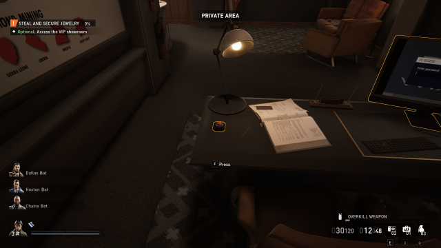 A red button on a desk with a book and lamp, the manager's office inside a Heist in Payday 3.