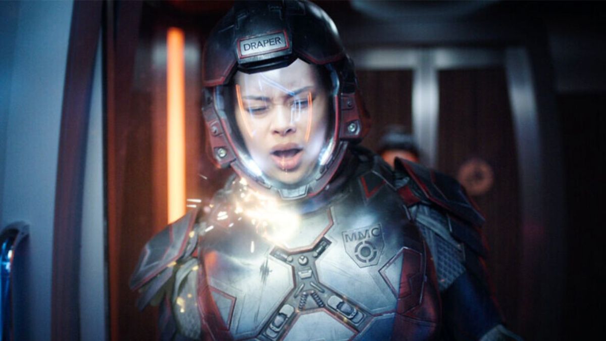 A woman wearing an astronaut suit in a ship hull in The Expanse