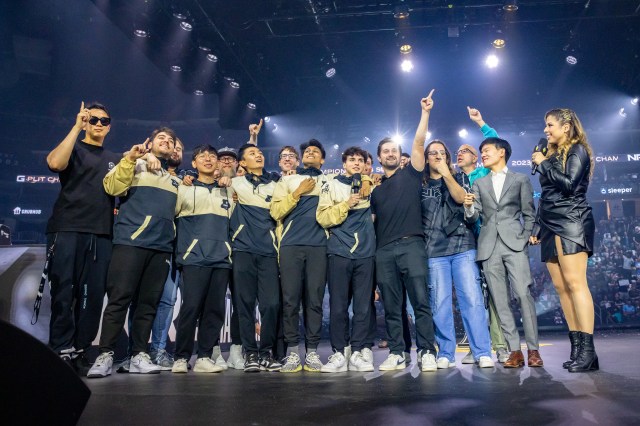 A large portion of the NRG staff, including its coaches and players, celebrate on the LCS Championship stage after their grand finals victory over C9.
