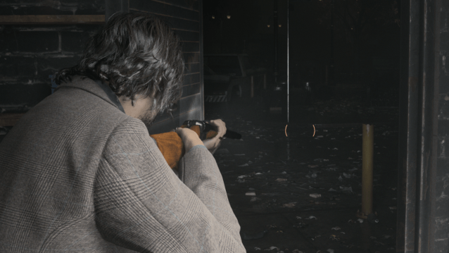 Alan Wake points a double-barreled shotgun