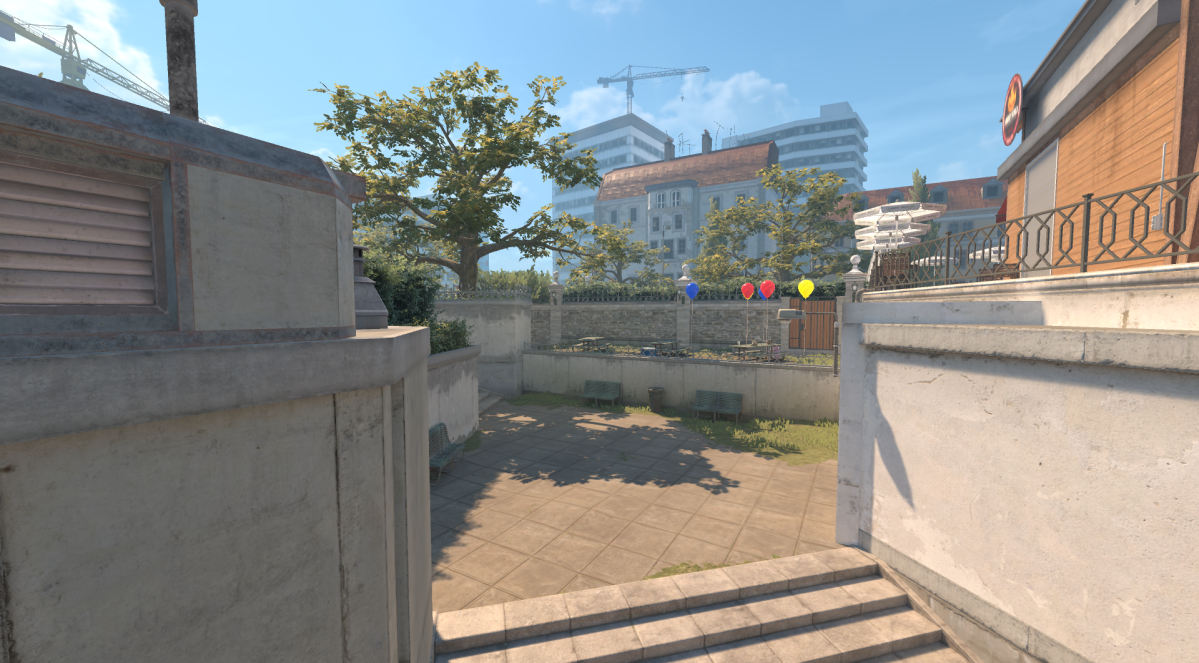 Screenshot taken of Overpass' Party in CS2, which features one blue balloon, one yellow balloon, and two red balloons.