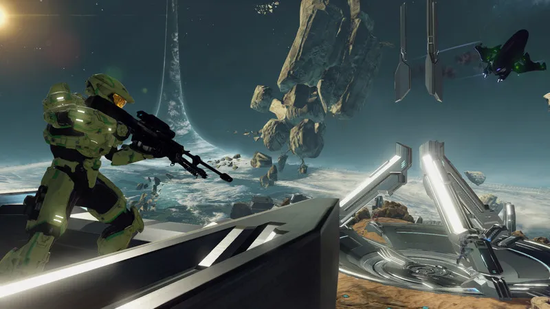 Master Chief looks over a ledge, equipped with a Sniper Rifle.