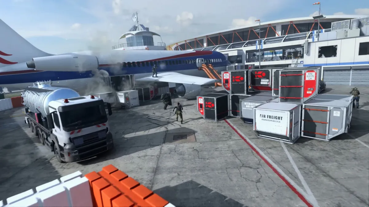 Image showcasing a multiplayer map in Call of Duty: MW3. There is a plane visible clearly in the middle of the battlefield and tanker trucks are scattered around. Red lines are paved on concrete.