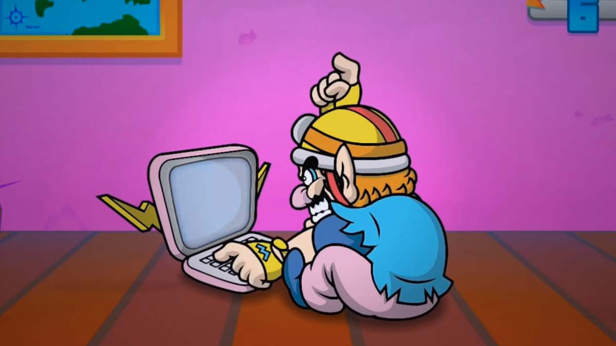 Wario typing angrily on a laptop of sorts.