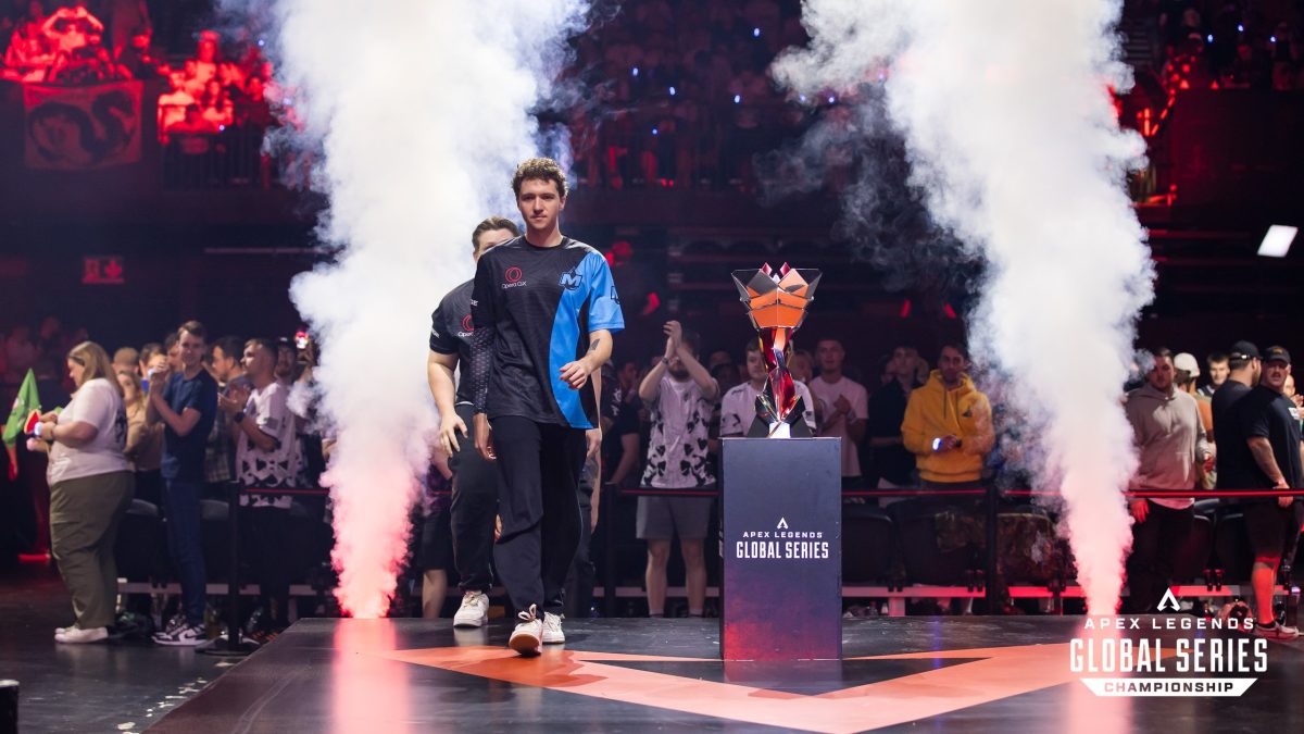 Emtee of Moist Esports walks past the ALGS Championship trophy as steam billows behind him.