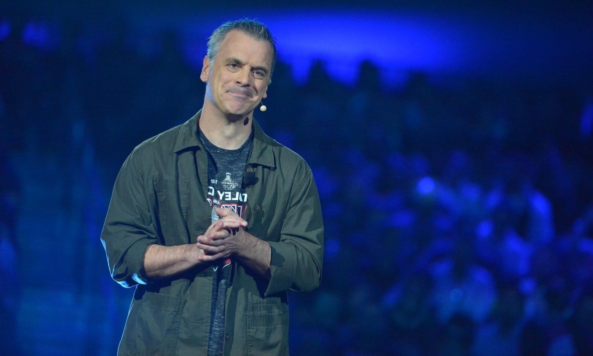 Pete Hines shown on stage at an Xbox event.