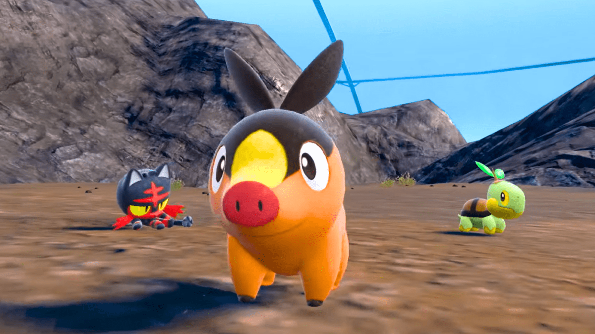 Litten, Tepig, and Turtwig standing in dirt in Pokémon Scarlet and Violet The Indigo Disk DLC.
