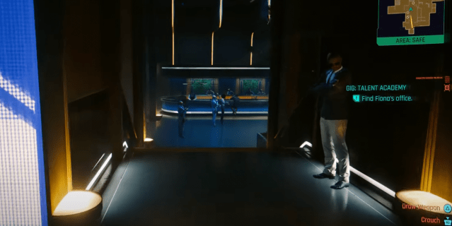Screenshot of a wide hallway with a blue room at the end of it. A security guard in a suit jacket, white shirt, and khakis stands guard.