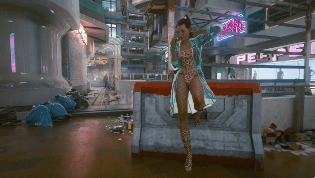 The female joytoy from Cyberpunk 2077 stands against a low wall. Screenshot by Dot Esports.